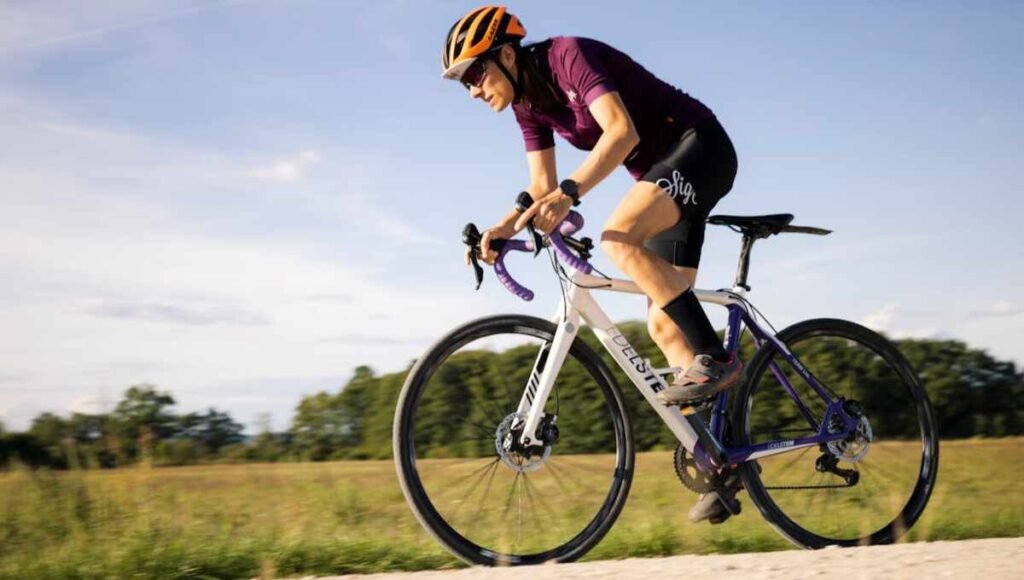 A cyclist riding their bike, looking determined to achieve their goal.