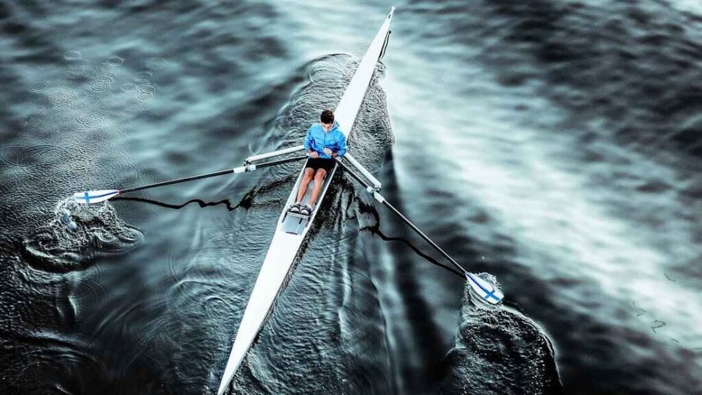 One person in a single scull boat, showing a wide range of fitness aspects.