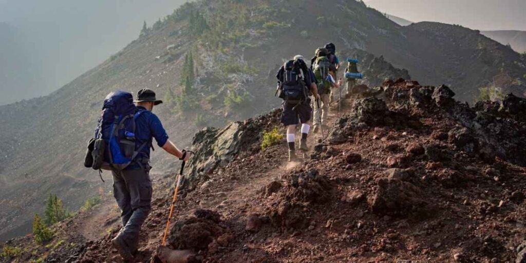 People hiking on a mountain, demonstrating strong willpower and determination to keep going.