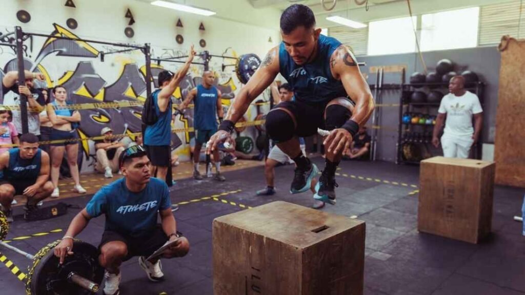 People performing box jumps during a group training session
